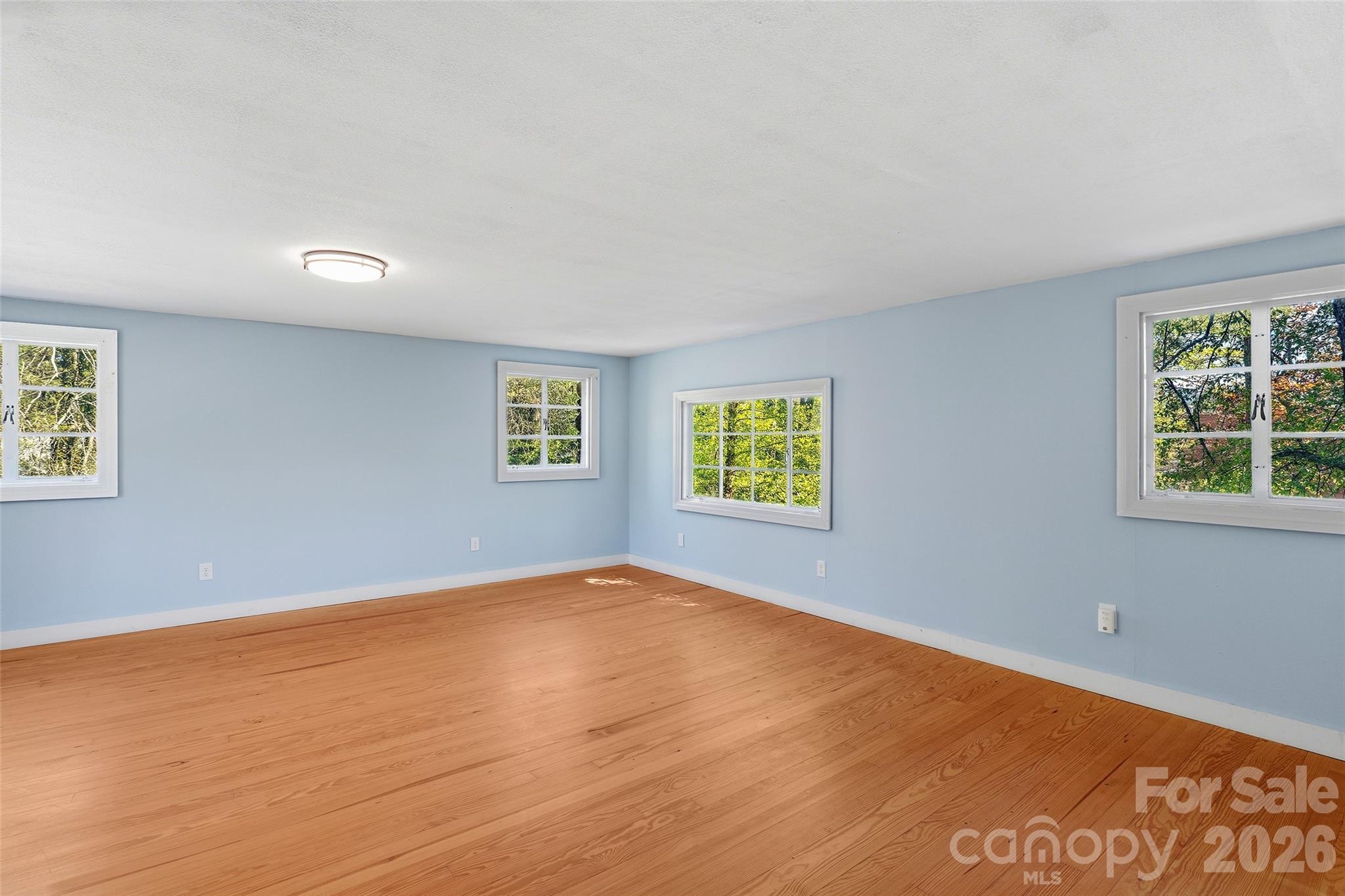 112 Candler School Road Candler, NC 28715 - Photo 27 of 37 wooden floor in an empty room with a window