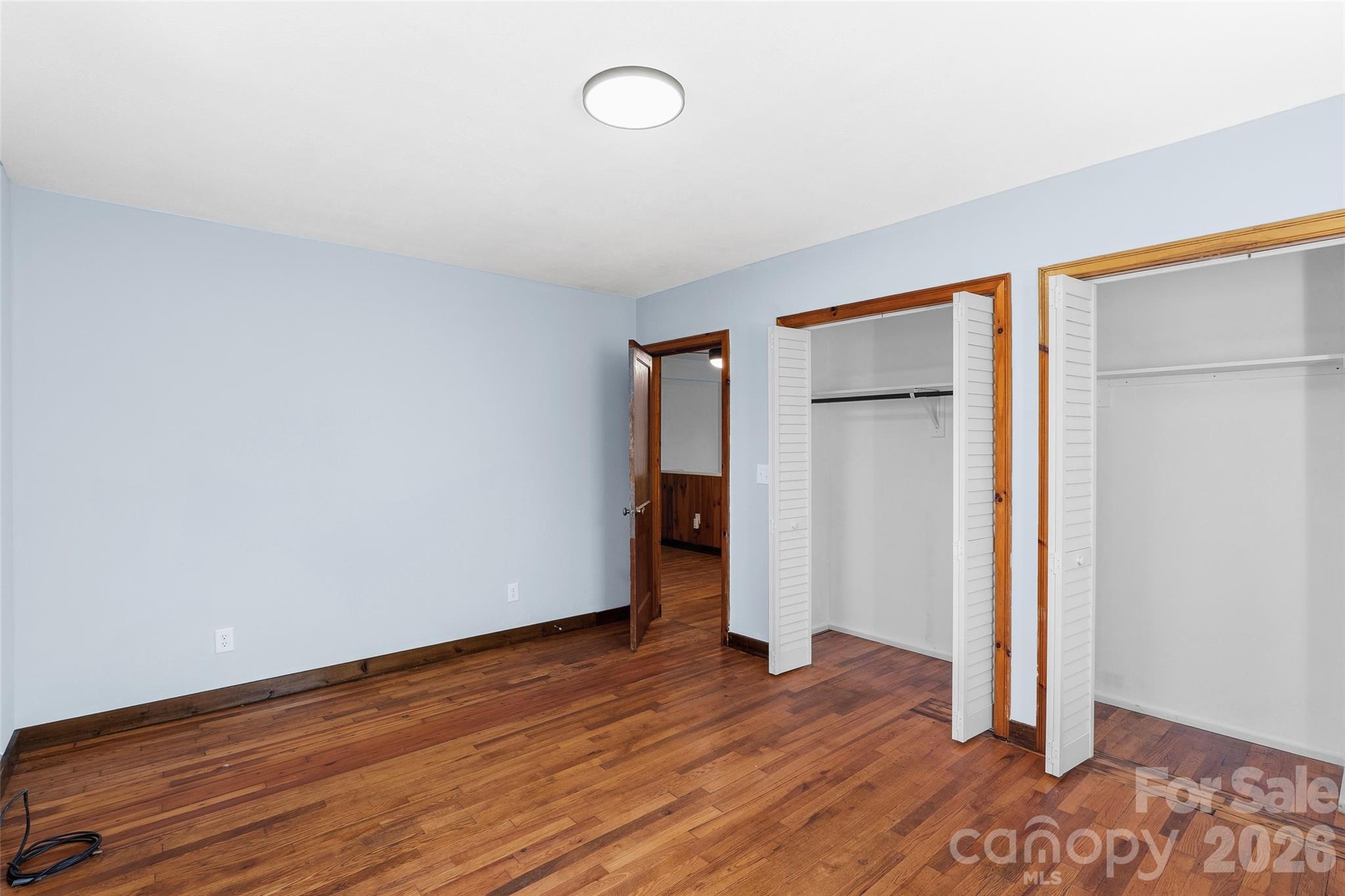 112 Candler School Road Candler, NC 28715 - Photo 28 of 37 an empty room with wooden floor and closet