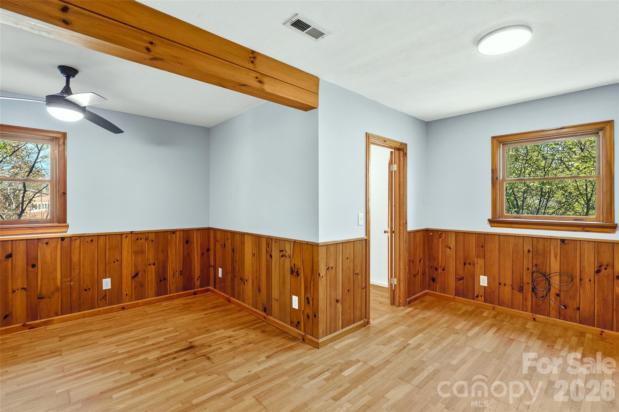 112 Candler School Road Candler, NC 28715 - Photo 30 of 37 a view of an empty room with window and wooden floor