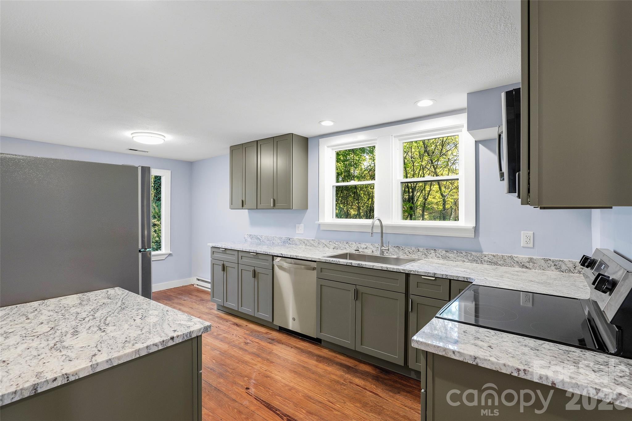 112 Candler School Road Candler, NC 28715 - Photo 10 of 37 a kitchen with a sink stove and cabinets