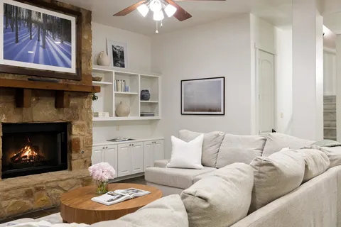 a living room with furniture and a fireplace