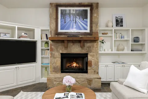 a living room with furniture a flat screen tv and a fireplace