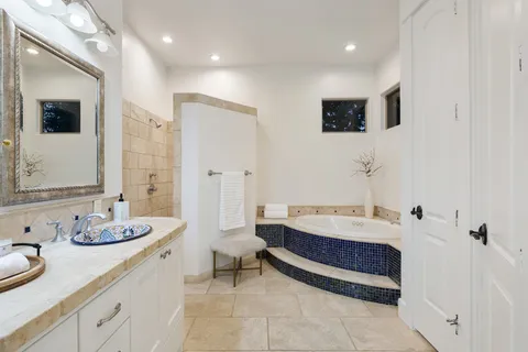 a spacious bathroom with a double vanity sink and a mirror