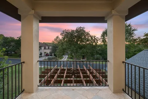 a living room with furniture a rug potted plant and a large window