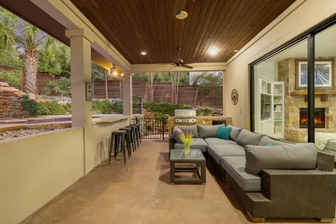 a roof deck with couches and potted plants