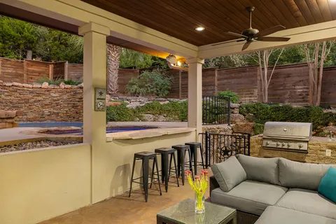 a view of a house with backyard and sitting area