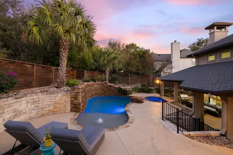 a swimming pool with outdoor seating and yard