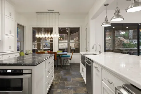 a kitchen with stainless steel appliances granite countertop a sink stove and cabinets