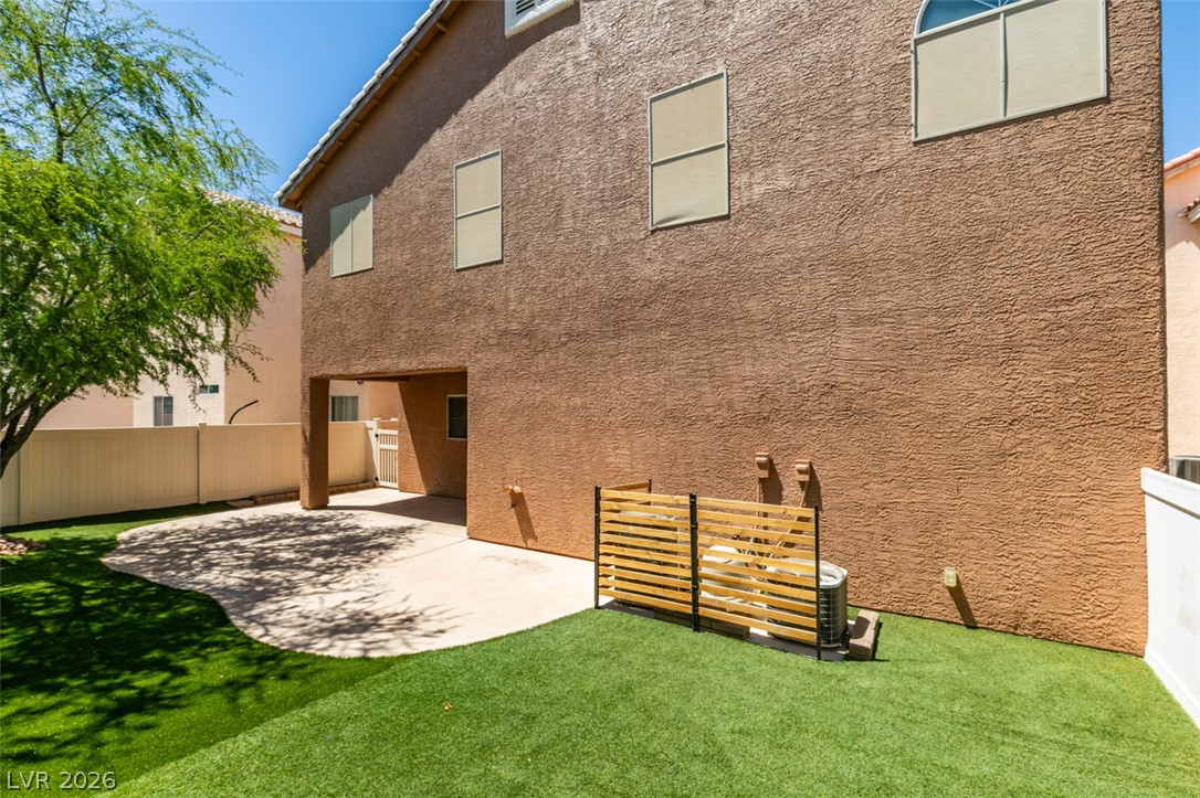 8909 Houston Ridge Avenue Las Vegas, NV 89178 - Photo 43 of 45 A well-maintained yard offers a covered patio area perfect for outdoor enjoyment.