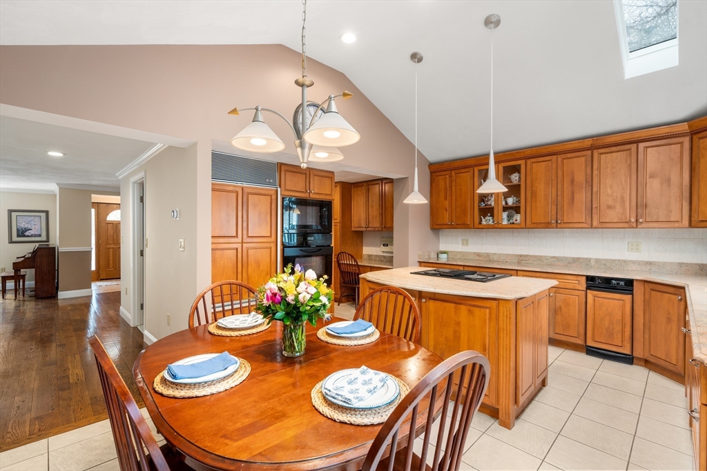 50 Stock Farm Road Sudbury, MA 01776 - Photo 13 of 40 a kitchen with stainless steel appliances granite countertop a sink a stove a dining table and chairs