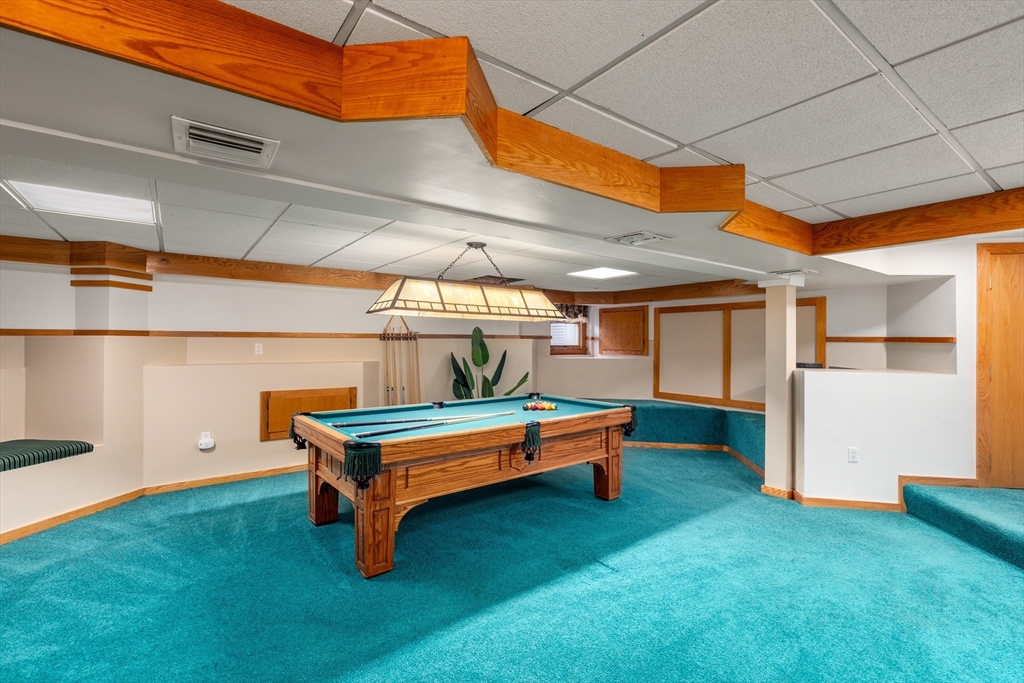 50 Stock Farm Road Sudbury, MA 01776 - Photo 28 of 40 a backyard of a house with wooden floor and stairs