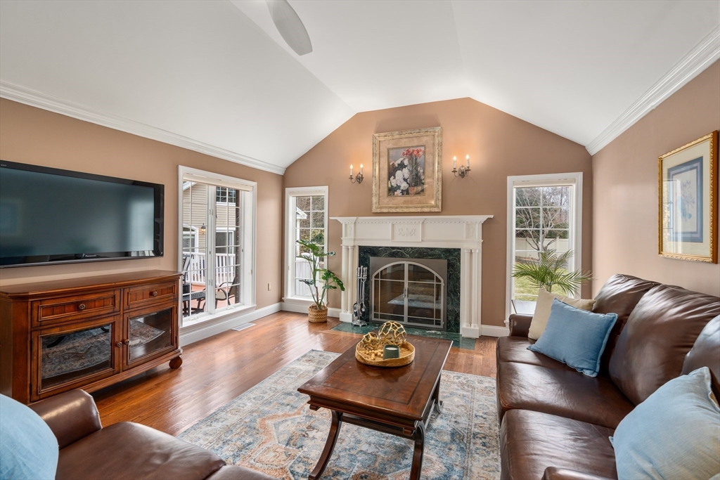 50 Stock Farm Road Sudbury, MA 01776 - Photo 6 of 40 a living room with furniture a flat screen tv and a fireplace