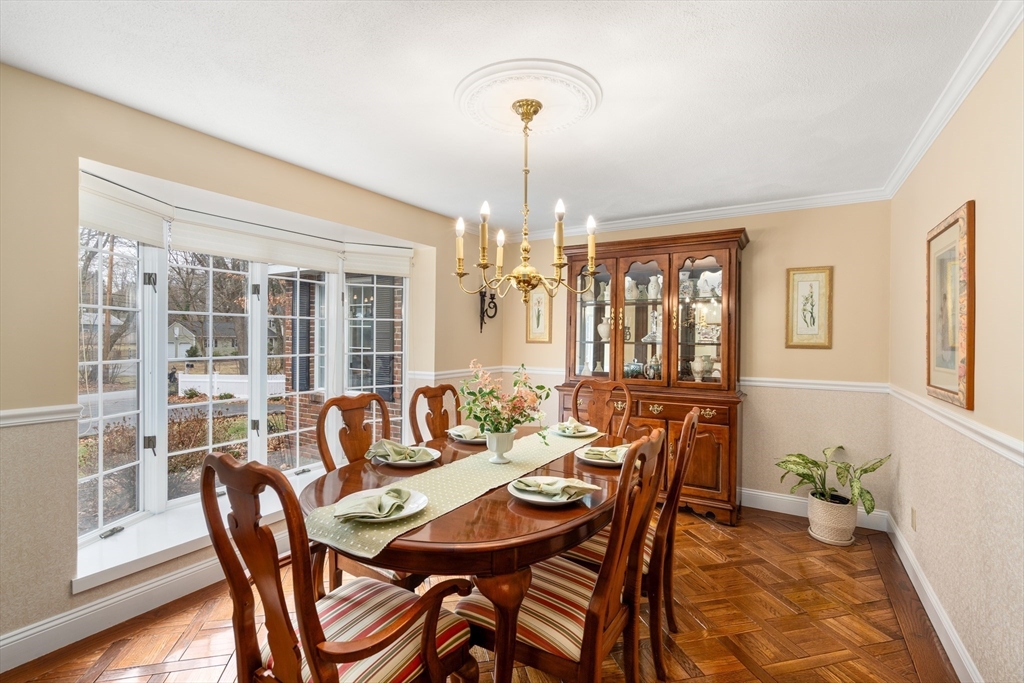 50 Stock Farm Road Sudbury, MA 01776 - Photo 8 of 40 a dining room with furniture a chandelier and wooden floor