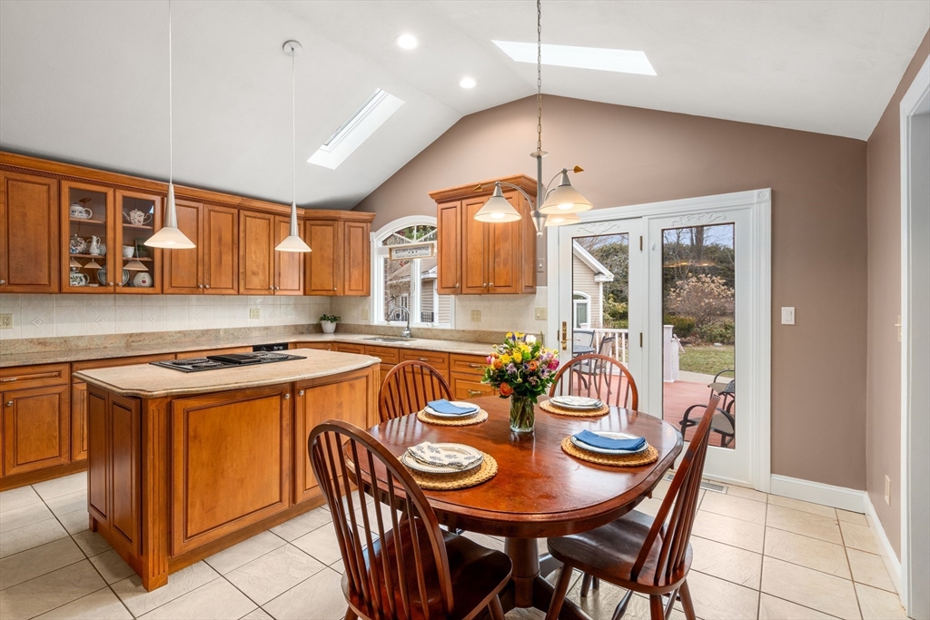 50 Stock Farm Road Sudbury, MA 01776 - Photo 10 of 40 a kitchen with stainless steel appliances granite countertop a stove a sink a dining table and chairs with wooden floor