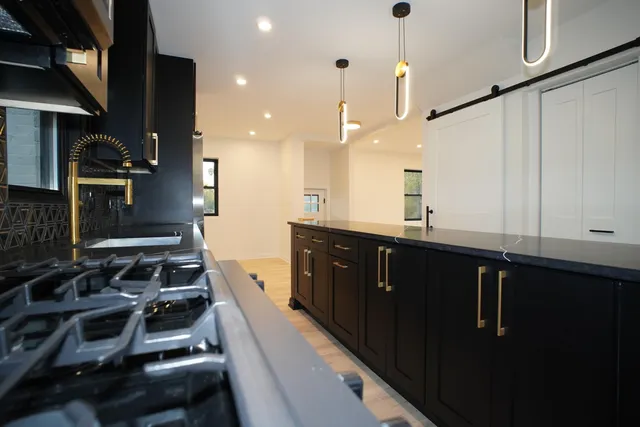 a kitchen with a sink stove and cabinets