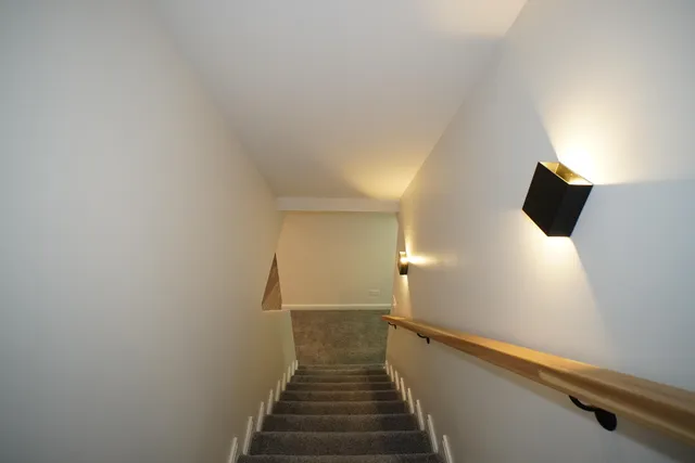 a view of a hallway with wooden floor and entryway