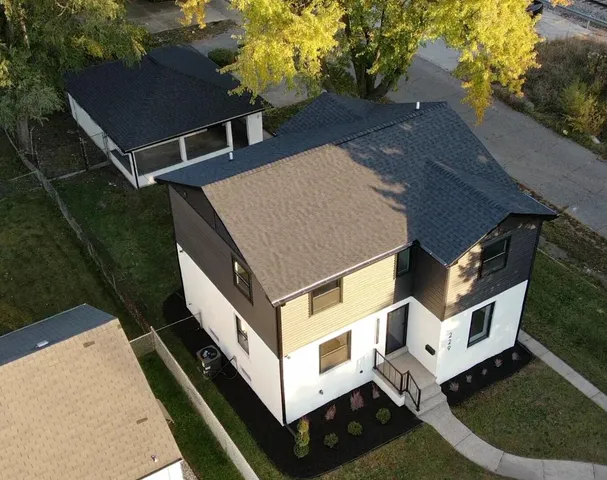 a aerial view of a house with a yard