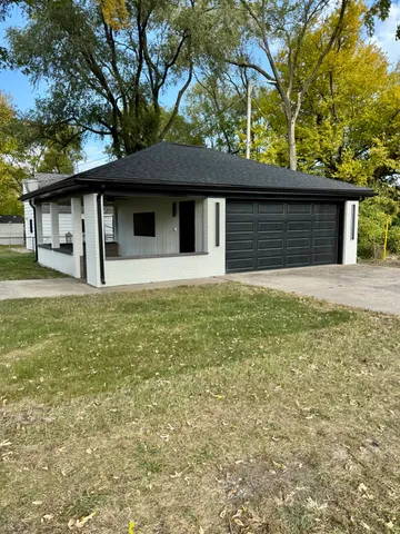 a house that has a tree in front of it