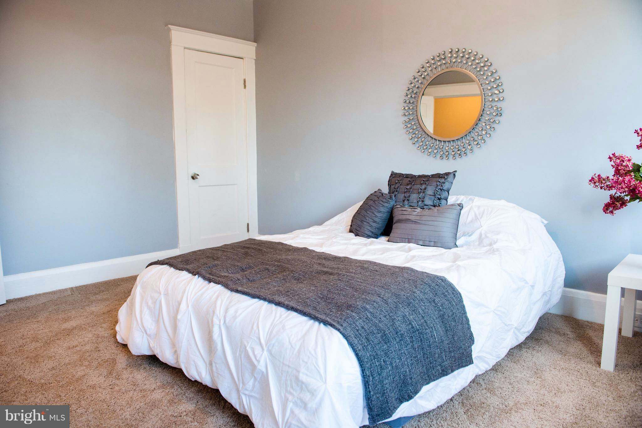 764 Edgewood Street Baltimore, MD 21229 - Photo 22 of 25 a bedroom with a bed and a window