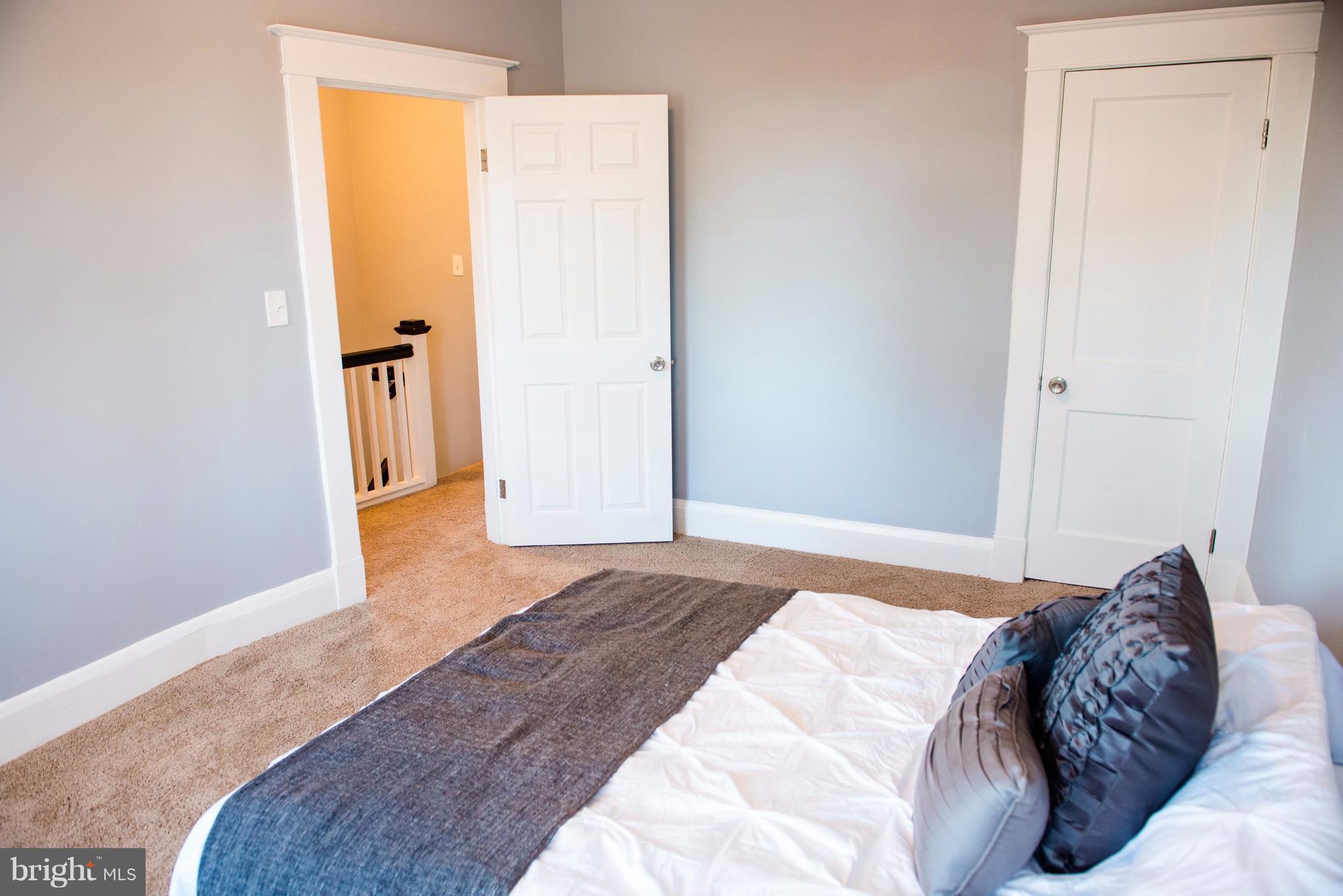 764 Edgewood Street Baltimore, MD 21229 - Photo 25 of 25 a bedroom with a bed and a refrigerator