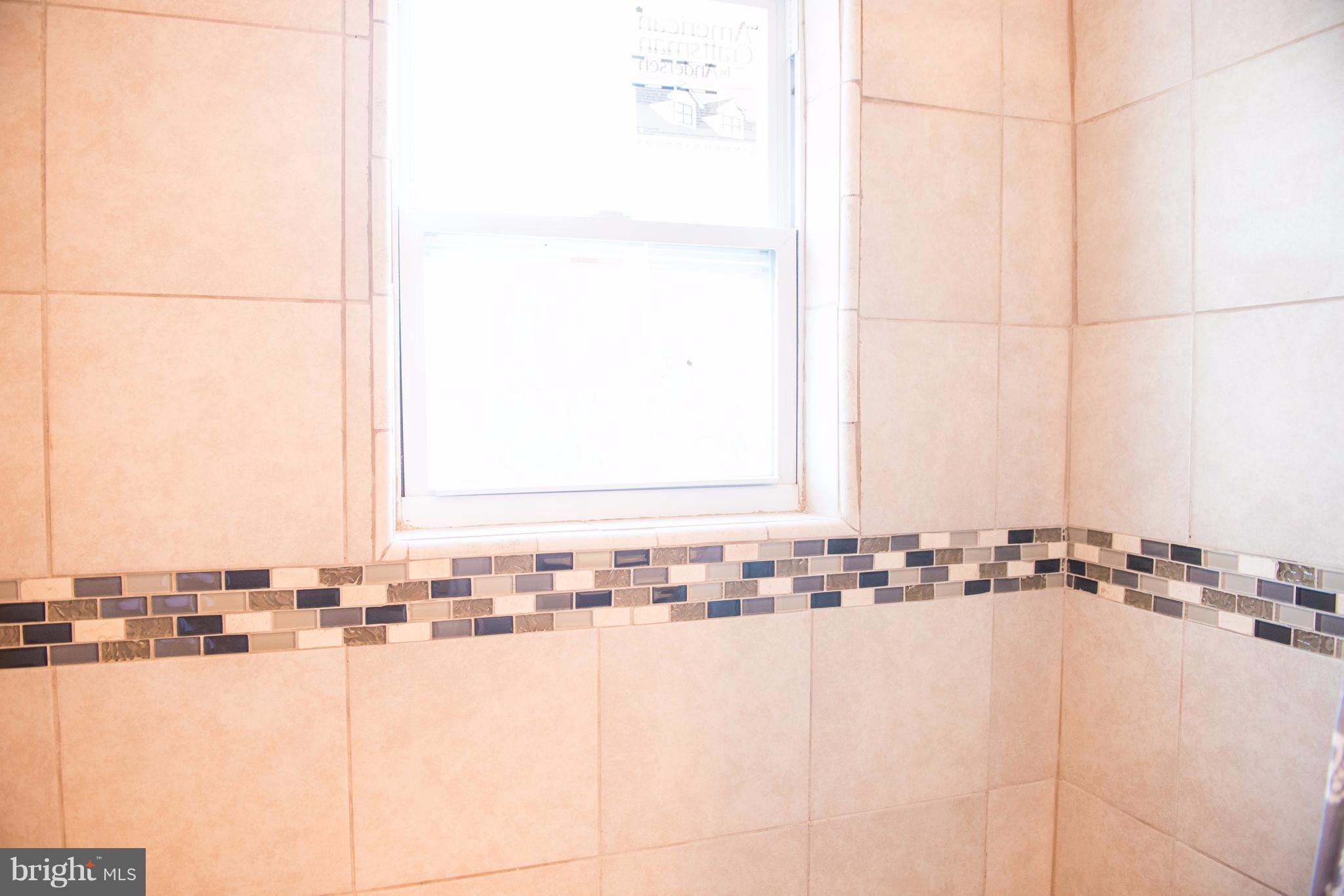 764 Edgewood Street Baltimore, MD 21229 - Photo 6 of 25 a bathroom with a bathtub and a sink