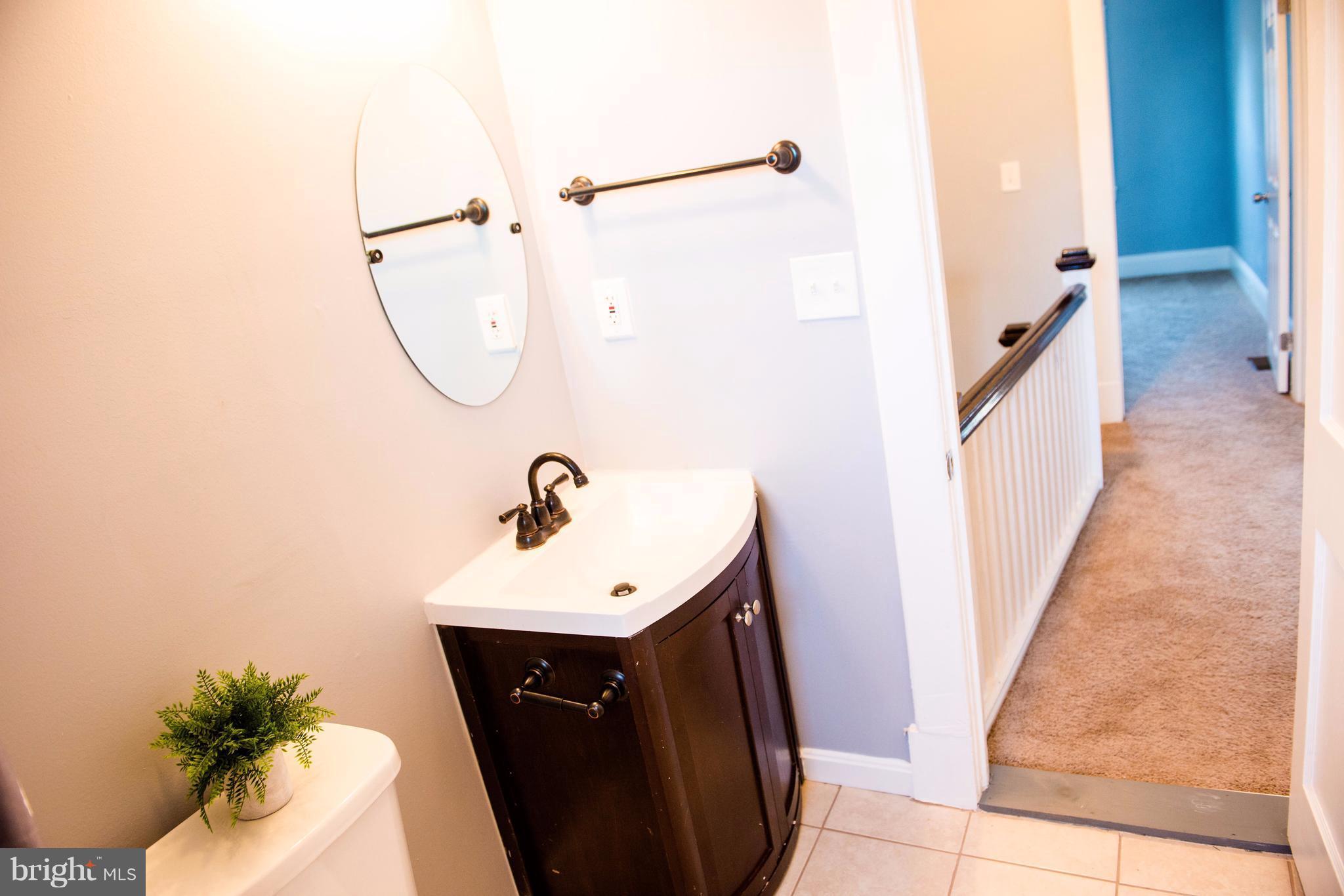 764 Edgewood Street Baltimore, MD 21229 - Photo 9 of 25 a bathroom with a sink a toilet and shower