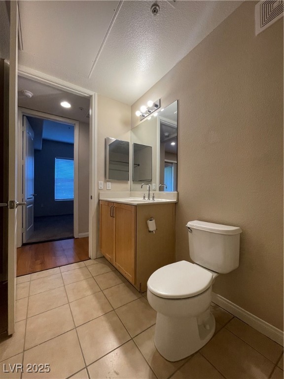 68 East Serene Avenue, Unit 225 Las Vegas, NV 89123 - Photo 14 of 22 Bathroom with light tile patterned floors, vanity, and a textured ceiling