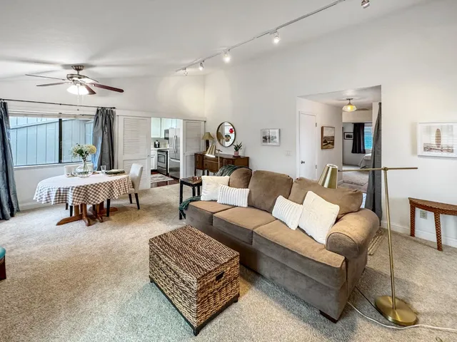 a living room with furniture and a lamp