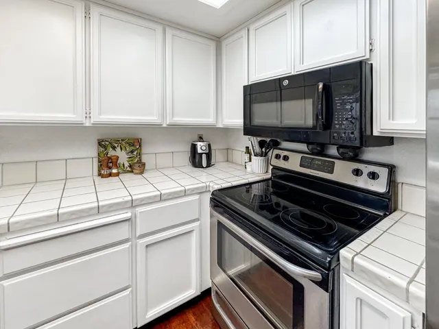 a kitchen with stainless steel appliances a stove a microwave and cabinets