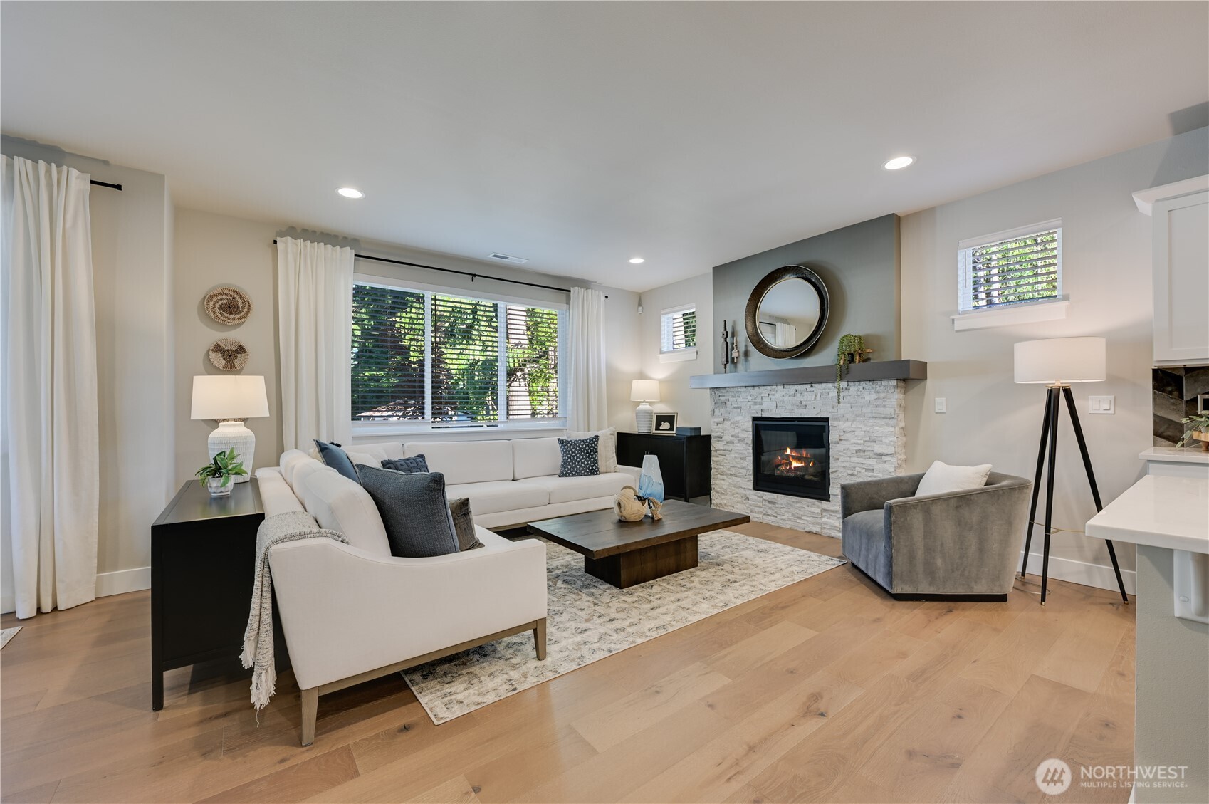 19231 Meridian Drive Southeast, Unit CW 13 Bothell, WA 98012 - Photo 18 of 36 a living room with furniture a large window and a fireplace