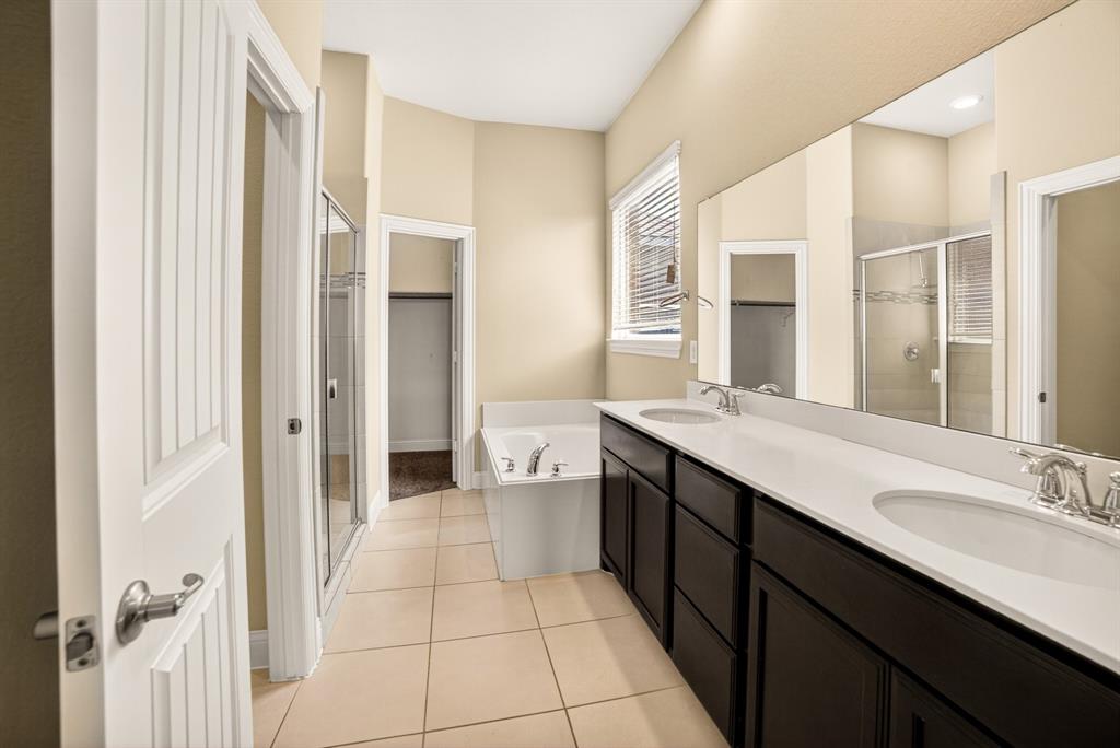 552 Winnetka Drive Oak Point, TX 75068 - Photo 27 of 40 a spacious bathroom with a double vanity sink a mirror and a