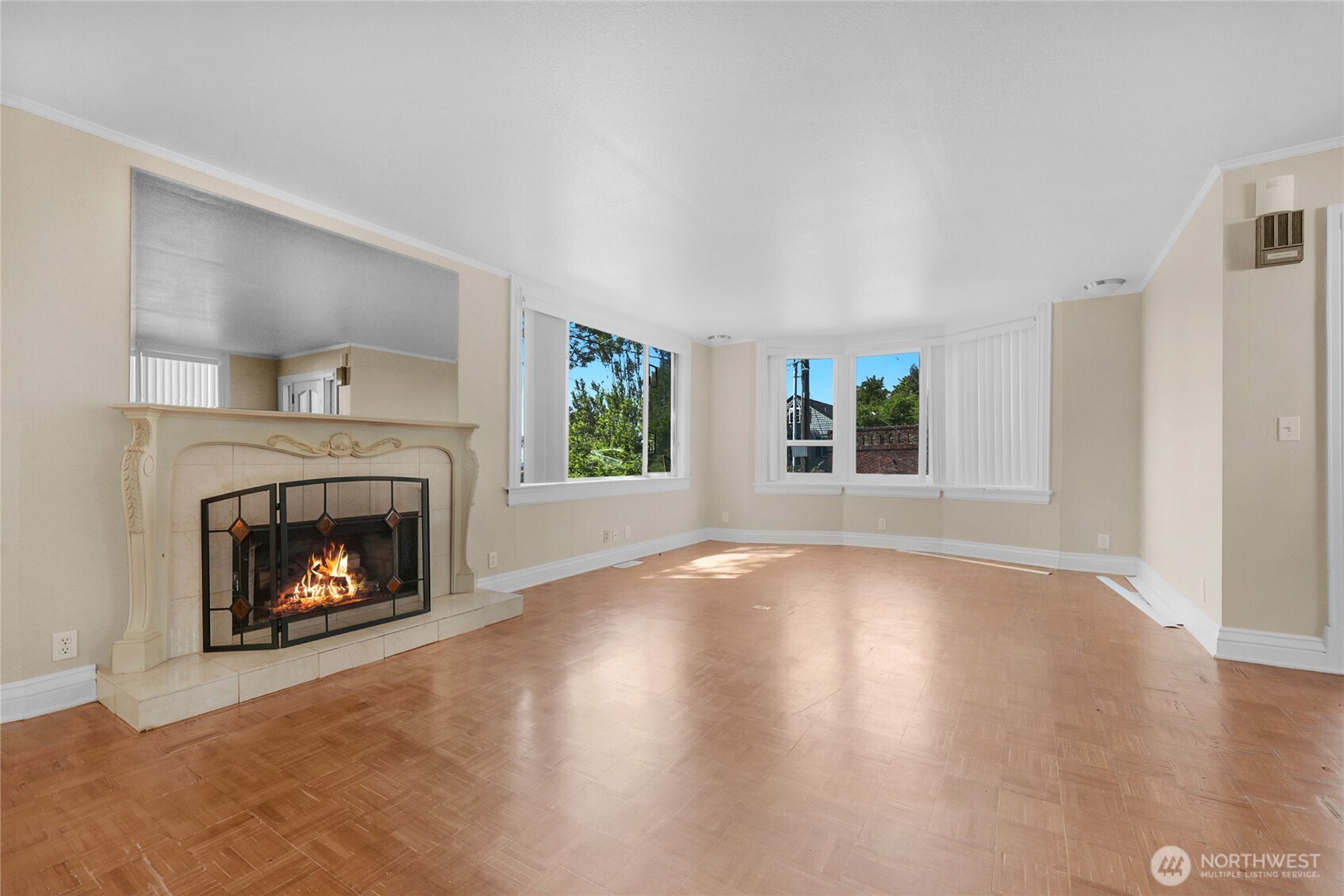 924 3rd Avenue West Seattle, WA 98119 - Photo 5 of 18 a view of an empty room with wooden floor fireplace and a window