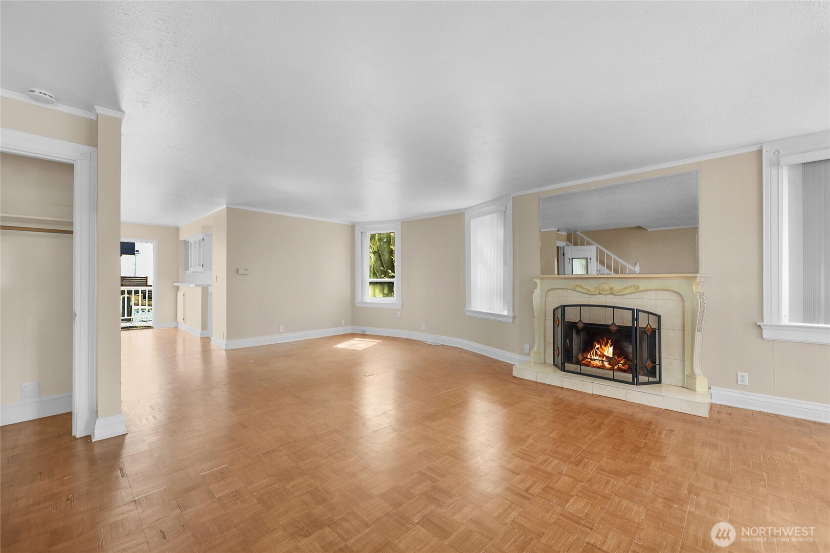 924 3rd Avenue West Seattle, WA 98119 - Photo 6 of 18 a view of an empty room with wooden floor fireplace and a window