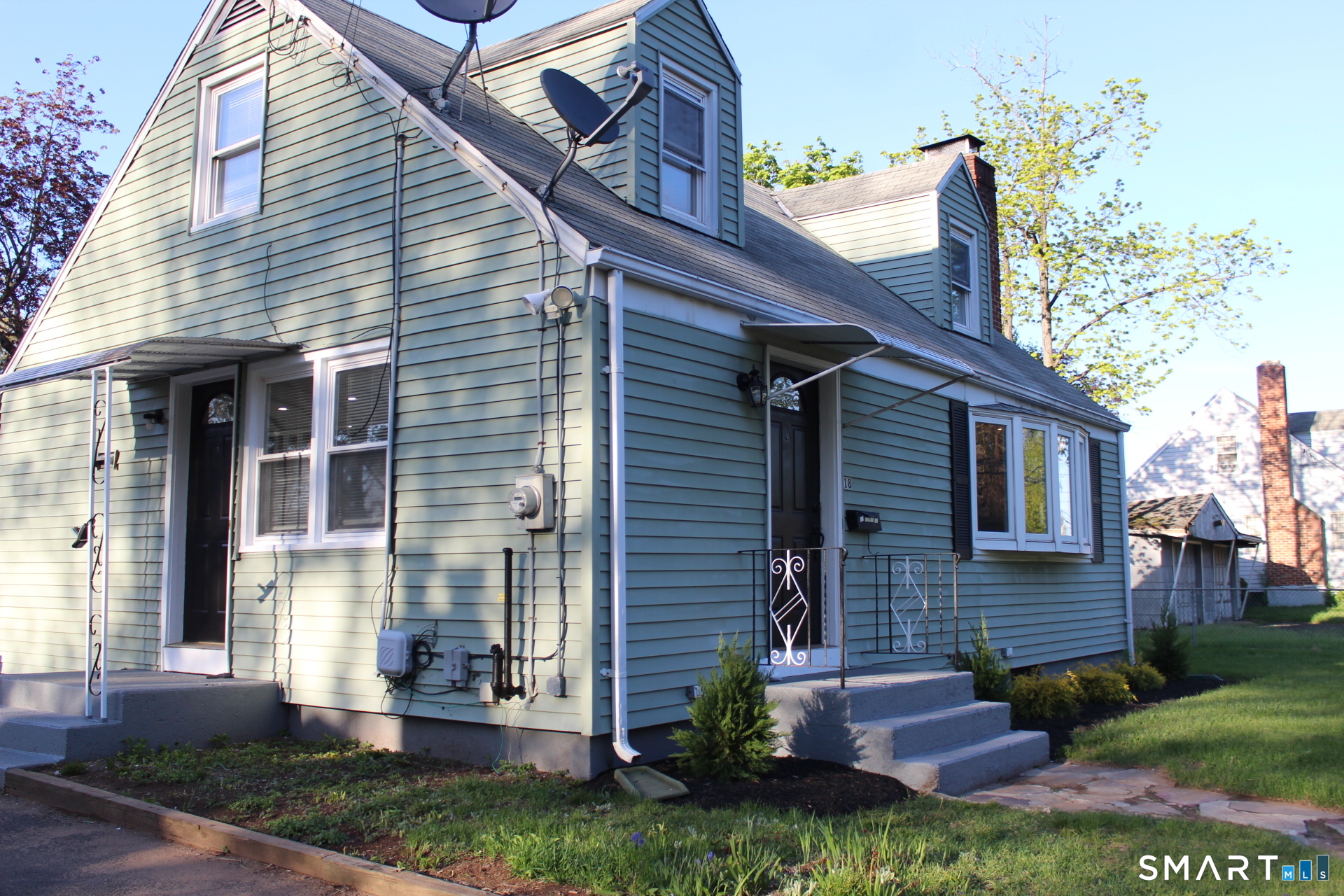 18 Walsh Street Bloomfield, CT 06002 - Photo 2 of 14 a view of a brick house with a yard potted plants and a table