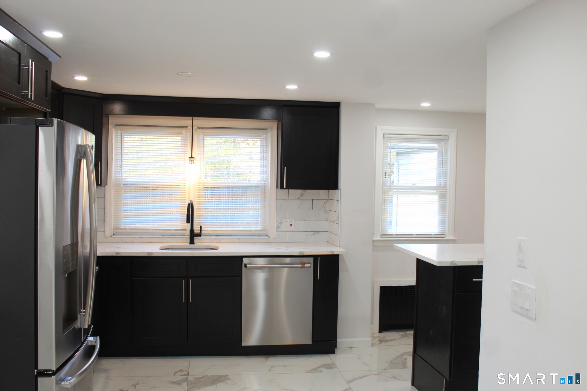 18 Walsh Street Bloomfield, CT 06002 - Photo 3 of 14 a kitchen with stainless steel appliances granite countertop a refrigerator a sink and a microwave