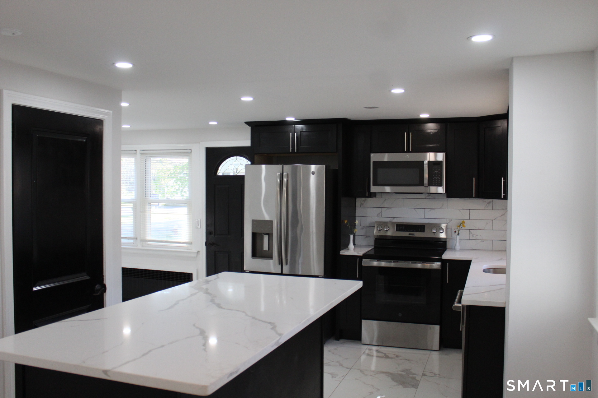 18 Walsh Street Bloomfield, CT 06002 - Photo 5 of 14 a kitchen with stainless steel appliances a refrigerator and a stove top oven