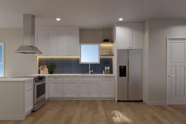 a kitchen with stainless steel appliances a sink a stove a refrigerator and cabinets