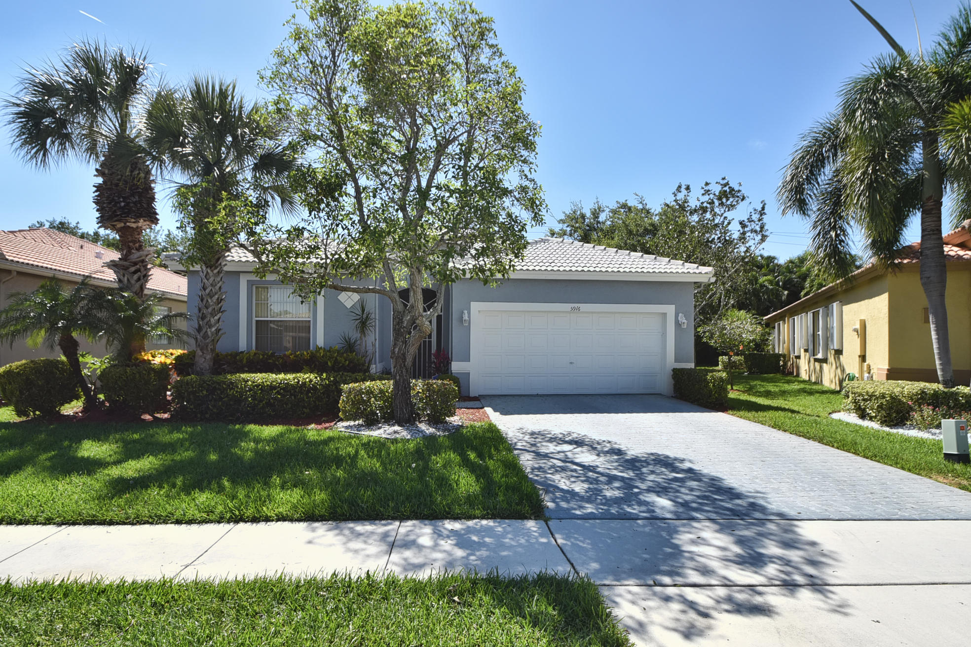 a front view of a house with a yard and a garage