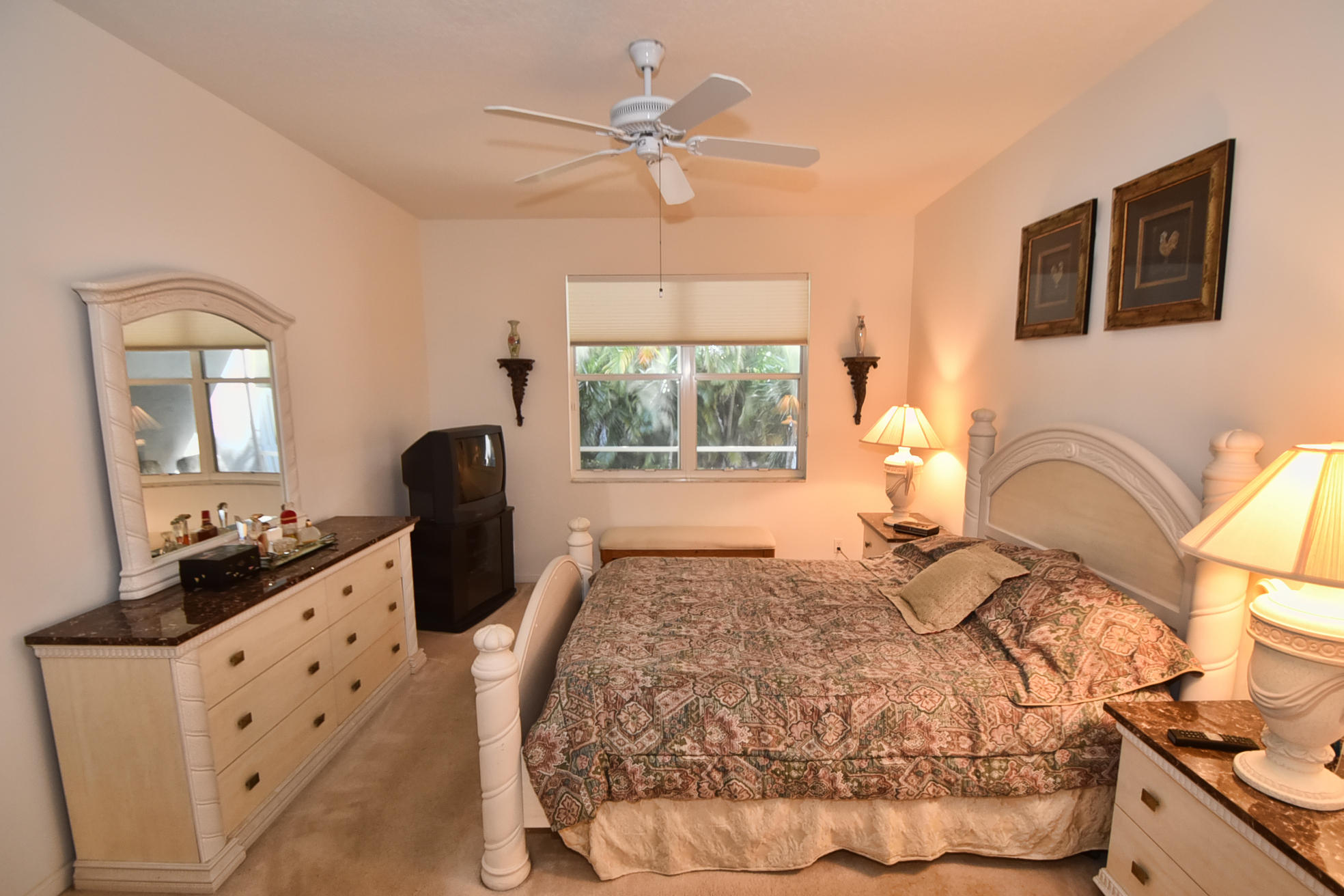 5916 Seashell Terrace Boynton Beach, FL 33437 - Photo 15 of 31 a bedroom with a bed and a chandelier