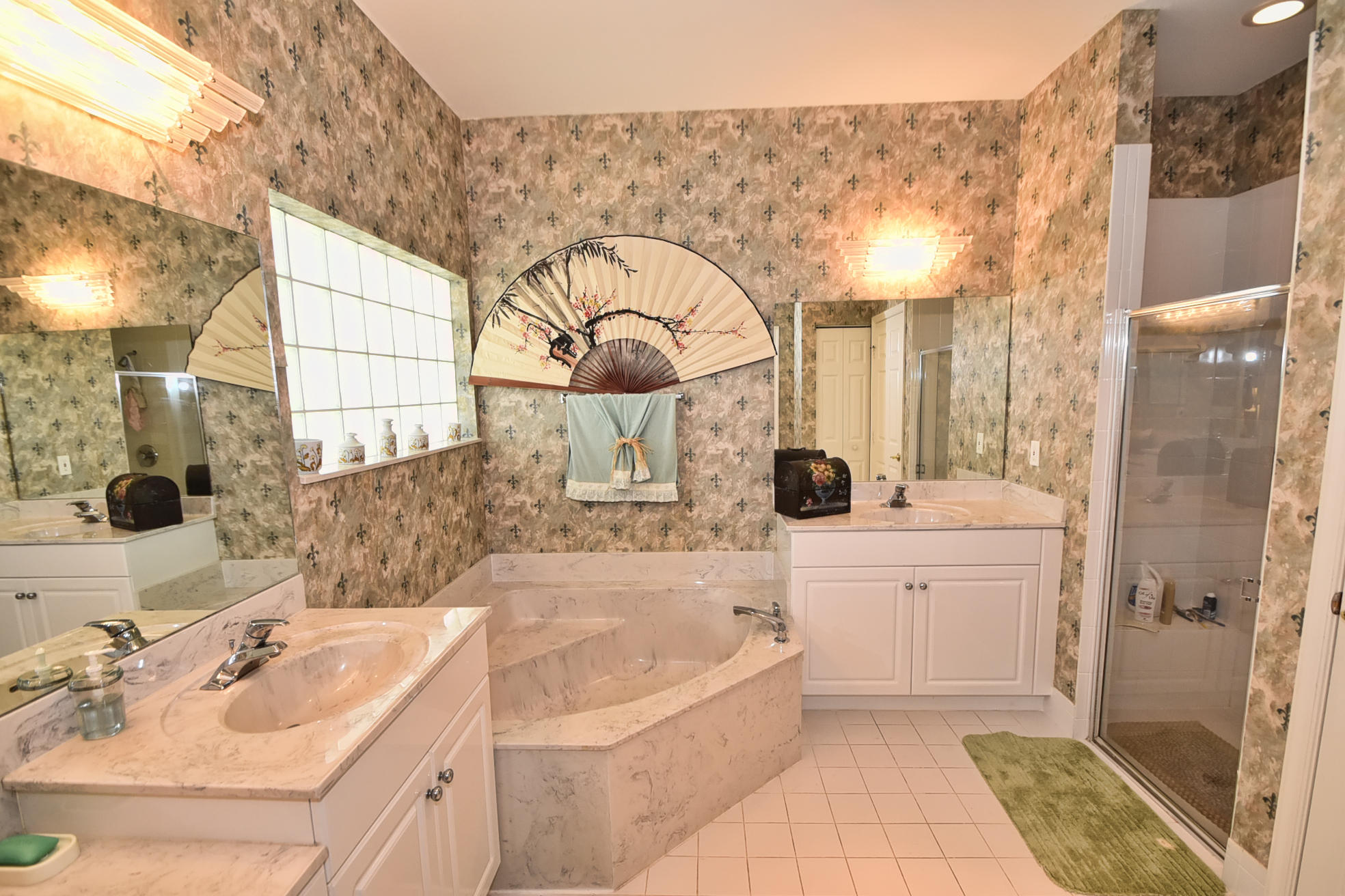 5916 Seashell Terrace Boynton Beach, FL 33437 - Photo 16 of 31 a bathroom with a tub sink and mirror