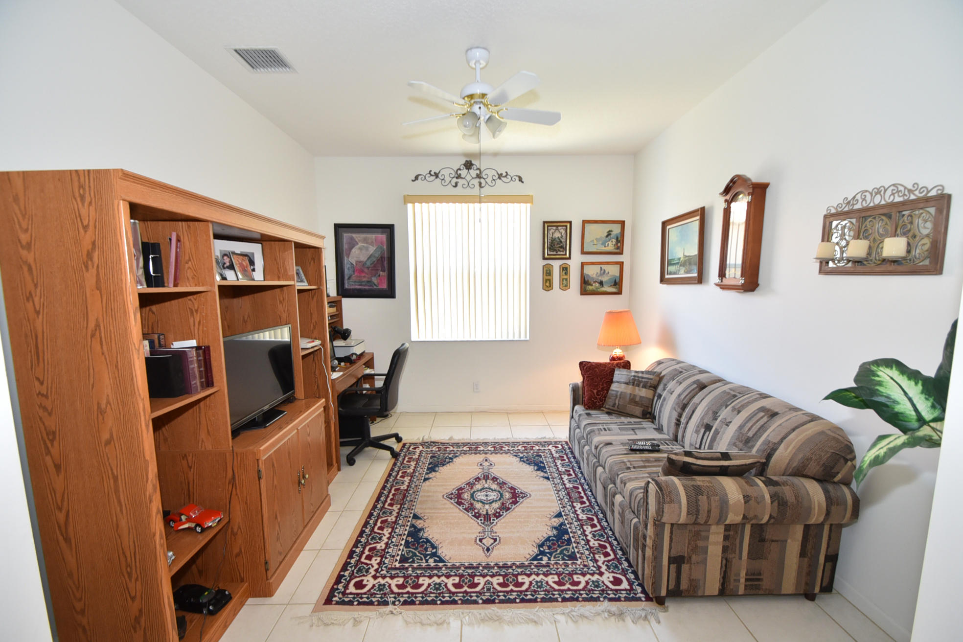 5916 Seashell Terrace Boynton Beach, FL 33437 - Photo 20 of 31 a living room with furniture and a chandelier