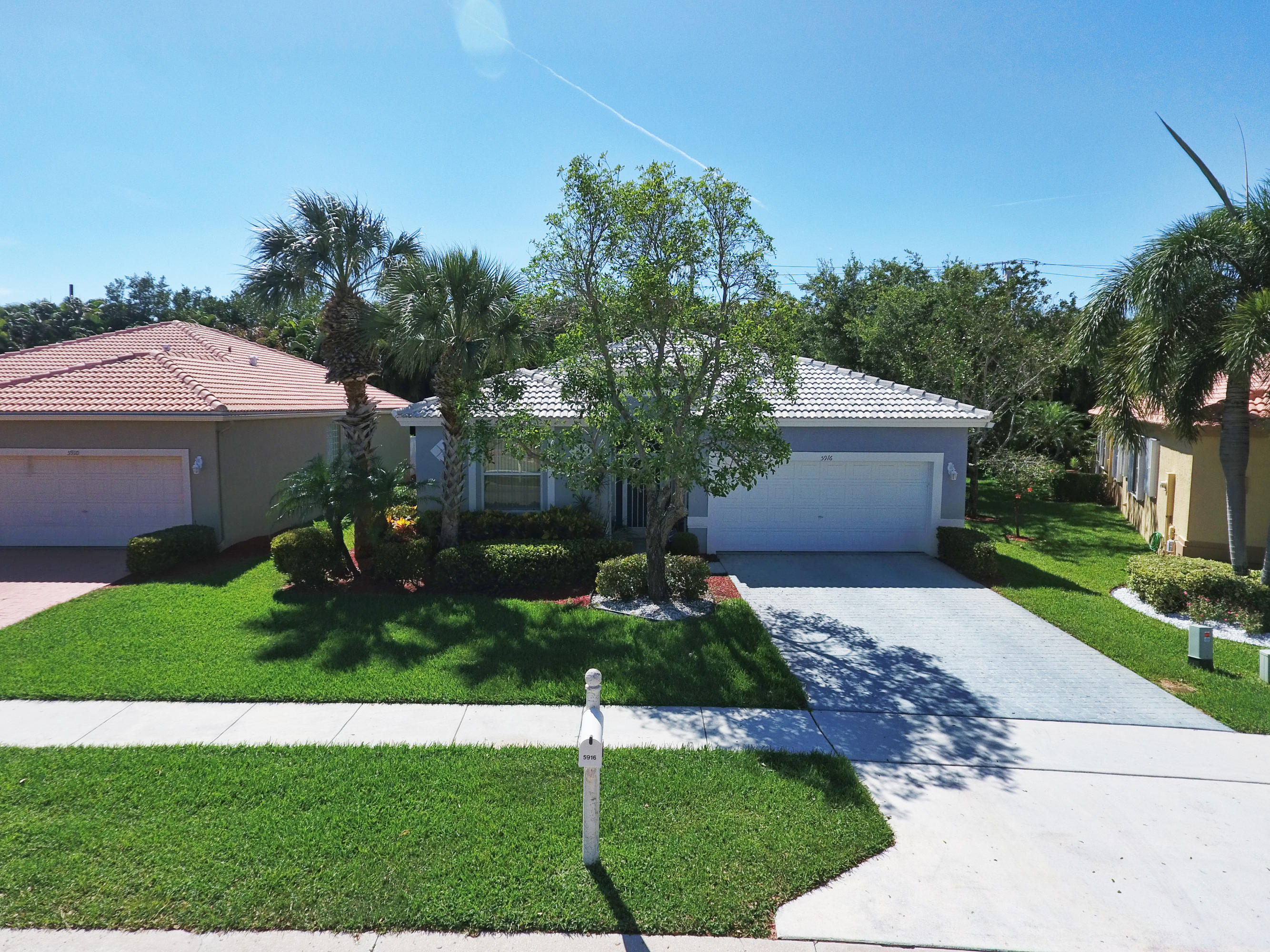 5916 Seashell Terrace Boynton Beach, FL 33437 - Photo 24 of 31 a front view of a house with garden