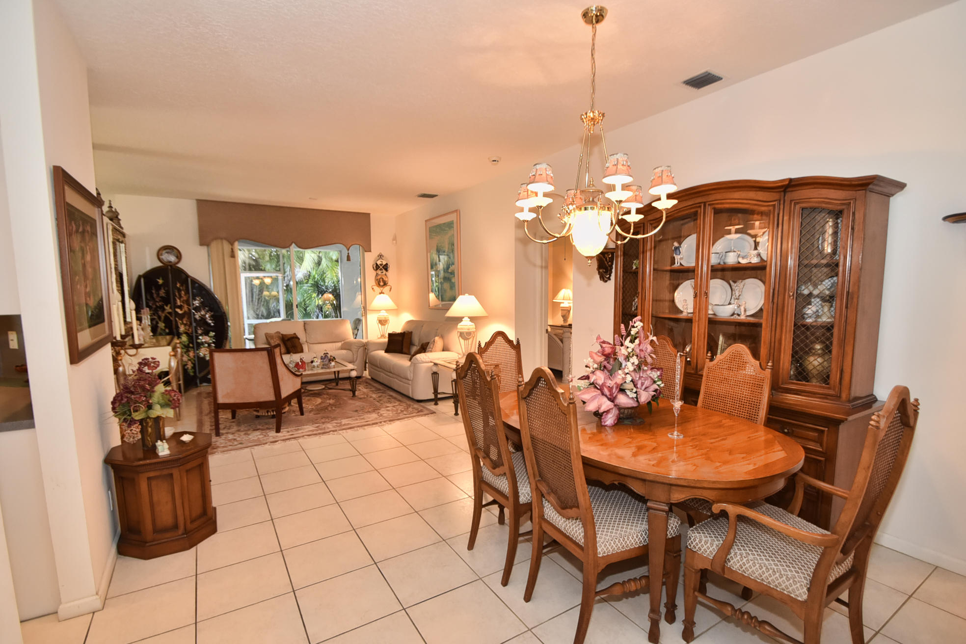 5916 Seashell Terrace Boynton Beach, FL 33437 - Photo 4 of 31 a view of a dining room with furniture and chandelier