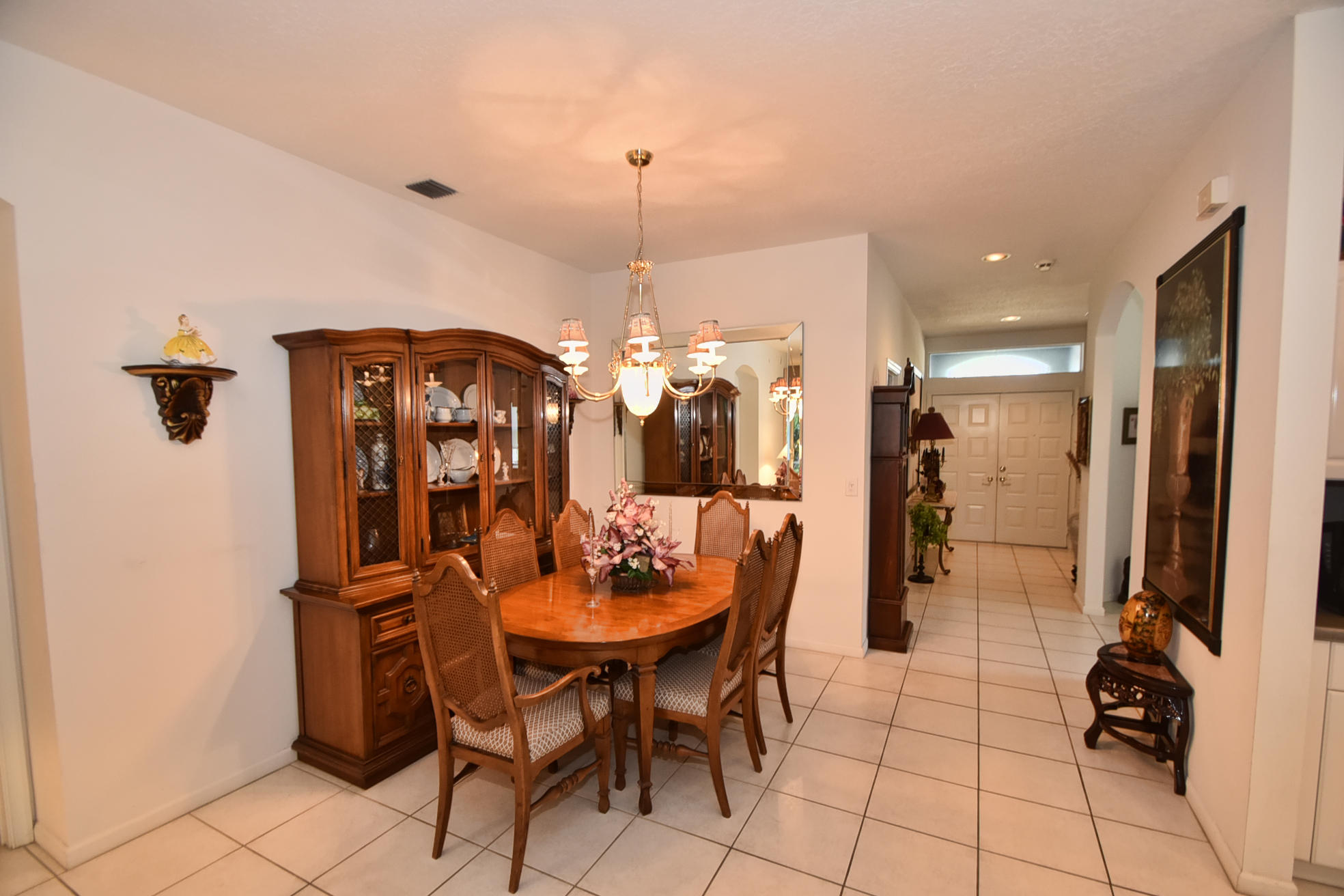 5916 Seashell Terrace Boynton Beach, FL 33437 - Photo 5 of 31 a dining room with furniture and a chandelier