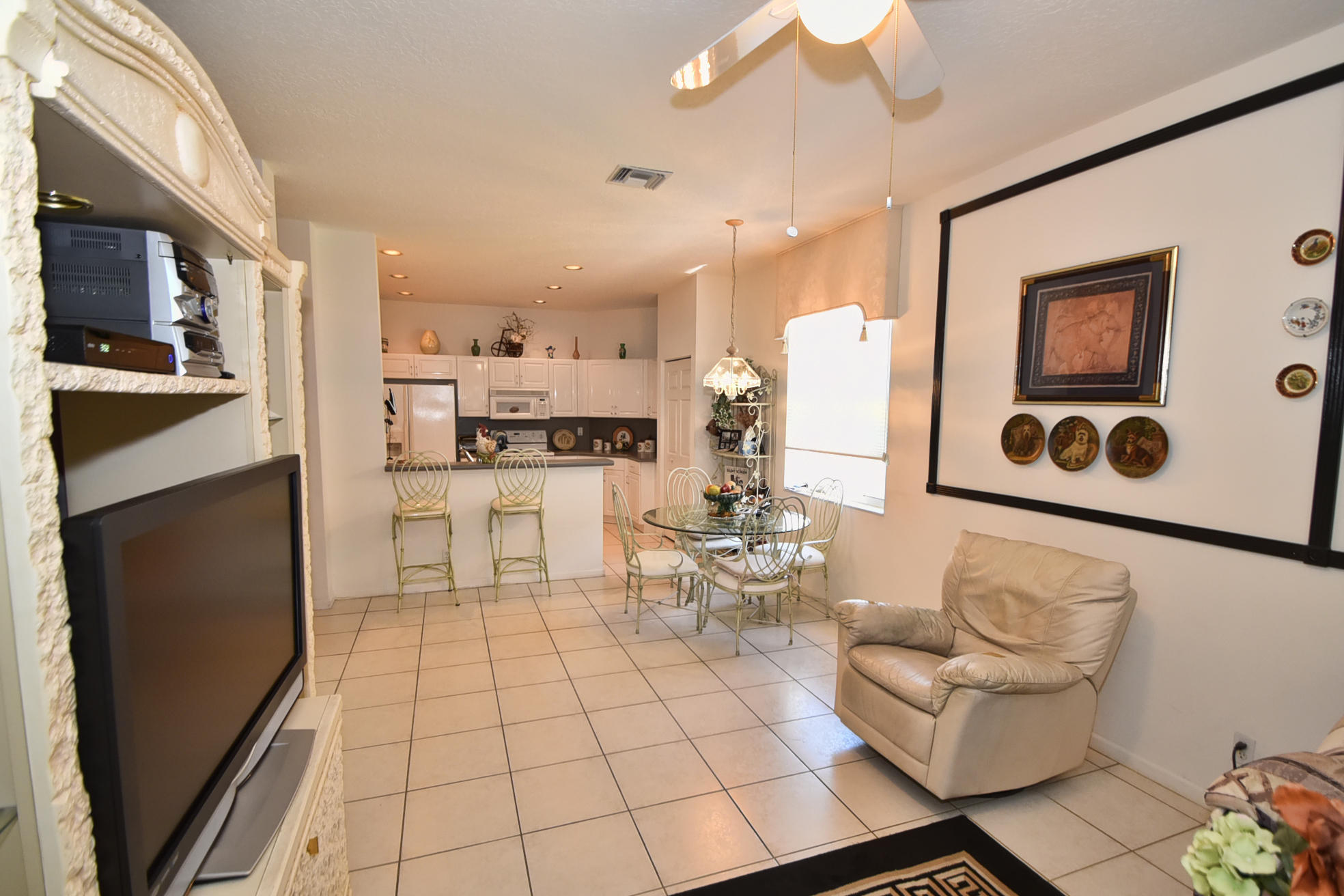 5916 Seashell Terrace Boynton Beach, FL 33437 - Photo 10 of 31 a living room with stainless steel appliances furniture a rug and a kitchen view