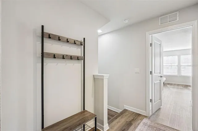 a view of a room with wooden floor
