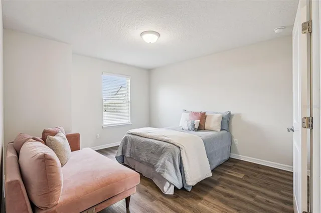 a bedroom with a bed and chair