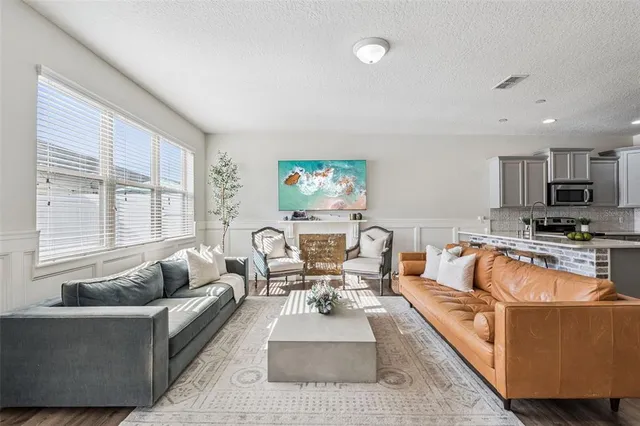 a living room with furniture and a large window