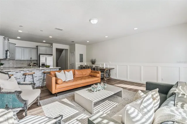 a living room with furniture and kitchen view
