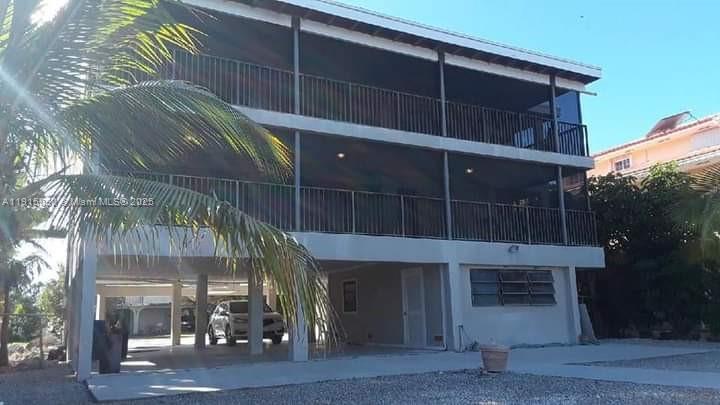26 South Exuma Road, Unit B Key Largo, FL 33037 - Photo 5 of 6 a front view of a house with a yard